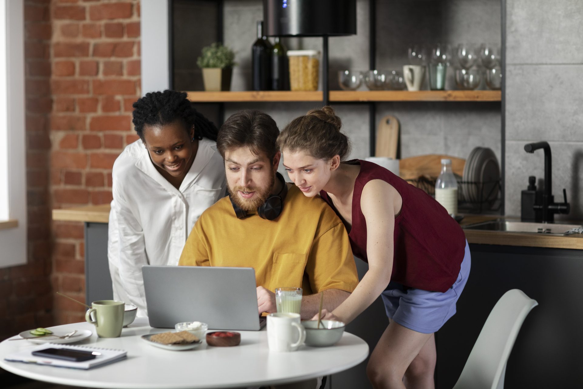 colleagues around a laptop