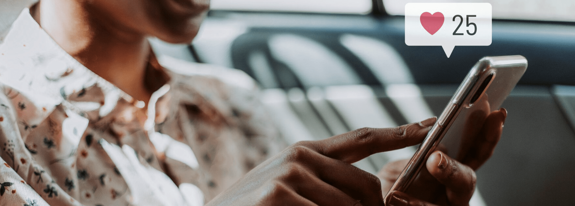 a lady scrolling on her phone with a like symbol from social media above the phone
